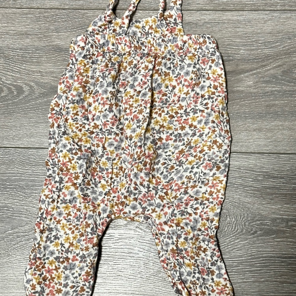 Flower romper with straps.